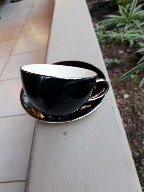 RENOWNED CERAMICS ARTIST PETER MTHOMBENI SIGNED TEA CUP & SAUCER BLACK WITH CHROME RIMS. WOW!