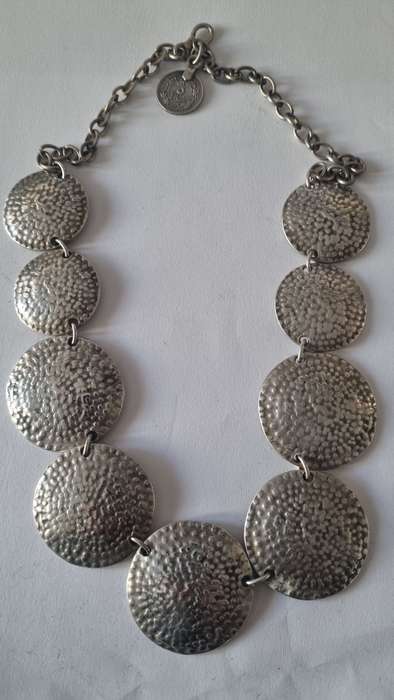 All metal necklace. Brass 9 discs and coin at clasp.