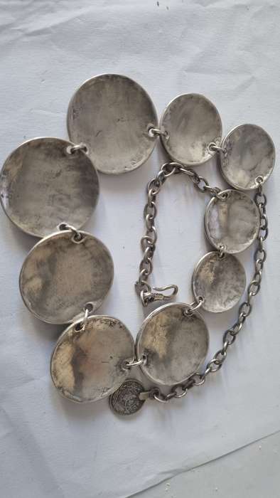 All metal necklace. Brass 9 discs and coin at clasp.