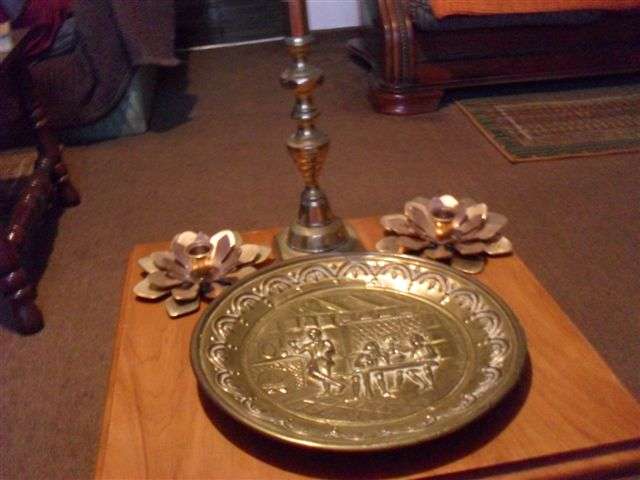 3 BRASS CANDLE HOLDERS AND A BRASS WALL PLATE