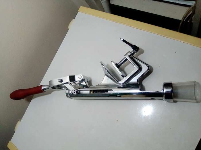 A manual working "Swing-A-Way" Ice crusher plus a table mounted Large wine bottle Cork puller.