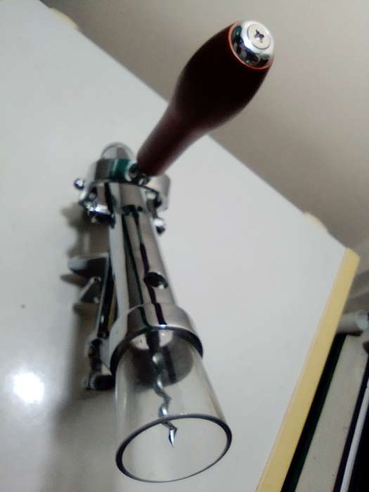 A manual working "Swing-A-Way" Ice crusher plus a table mounted Large wine bottle Cork puller.