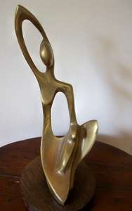 SOLID BRASS FIGURINE.  MOUNTED ON WOOD.