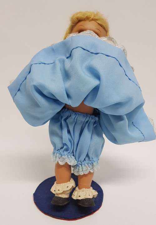 Vintage Hard Plastic Doll 26cm dressed in hand stitched dress on metal stand as per photo