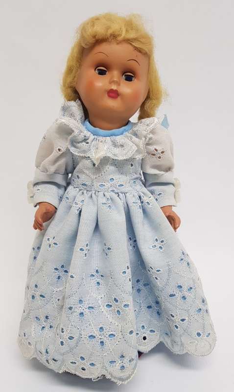 Vintage Hard Plastic Doll 26cm dressed in hand stitched dress on metal stand as per photo