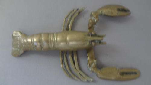 Brass crayfish with 1 missing leg due to fight with octopus