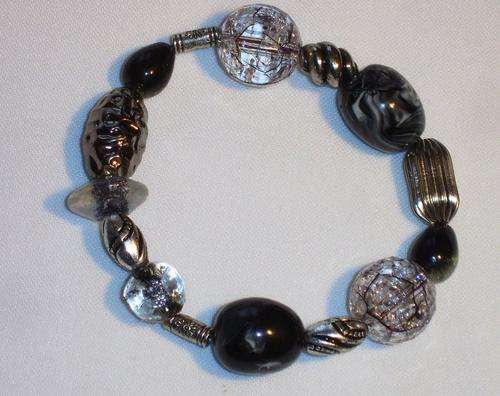BLACK SILVER AND GLASS COLOUR BRACELET.