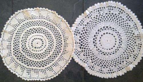 Two large cream wool crochet doilies