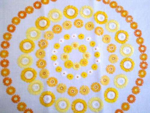 Orange and yellow daisy tablecloth / centerpiece plus colour co-ordinated doilie