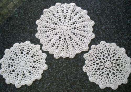 Set of three cream crochet wool doilies