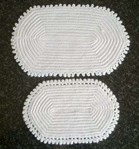 Two different white oval crochet doilies