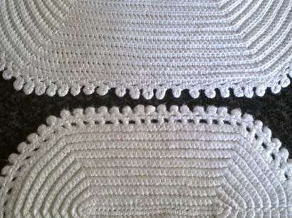 Two different white oval crochet doilies
