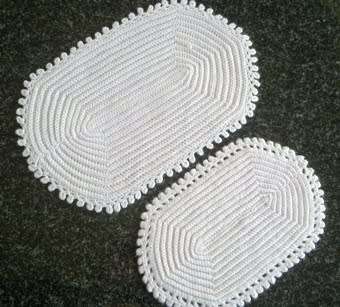 Two different white oval crochet doilies