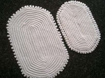 Two different white oval crochet doilies