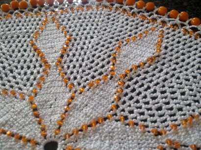 White cotton crochet doilie with orange glass beads 22cm