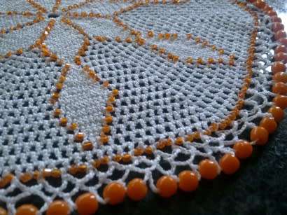 White cotton crochet doilie with orange glass beads 22cm