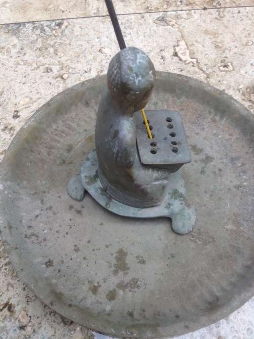 vintage brass buddha incense burner on brass plate