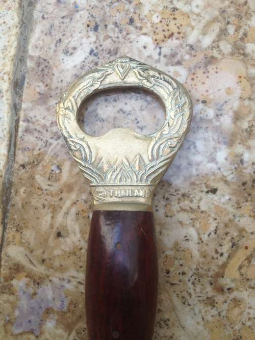 brass thai bell bottle opener