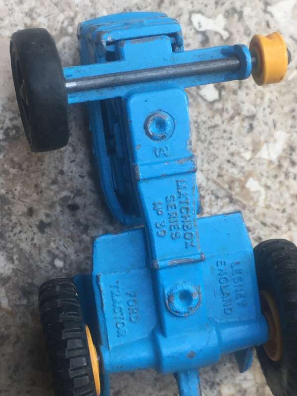 lesney matchbox series 39 ford tractor , missing a wheel , with spare Corgi wheels