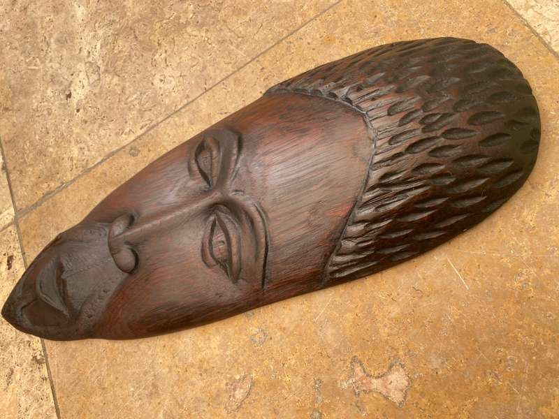 African wood face carving dark wood  , as if a  mask wall mount