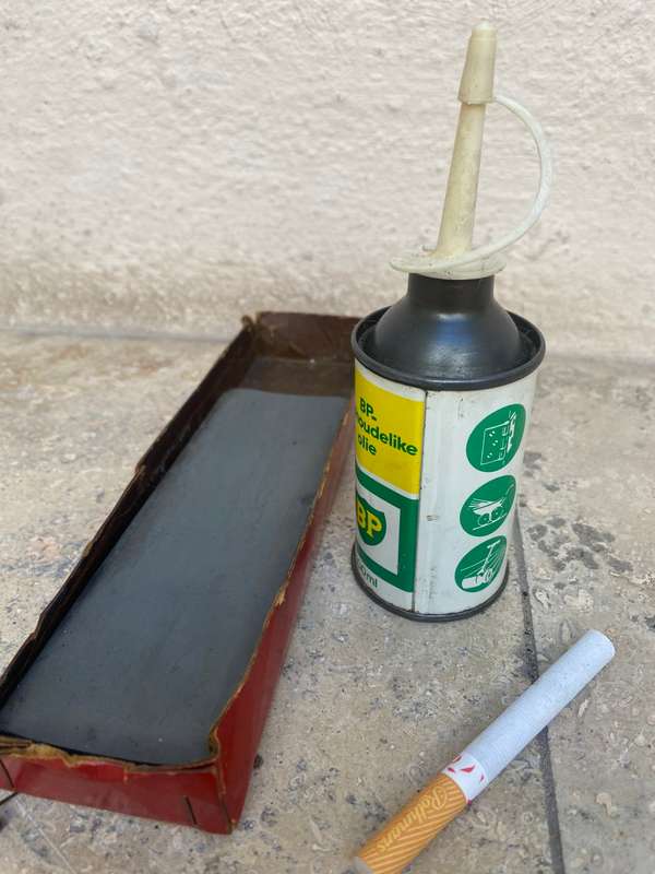 Vintage oil can BP with old sharpening stone