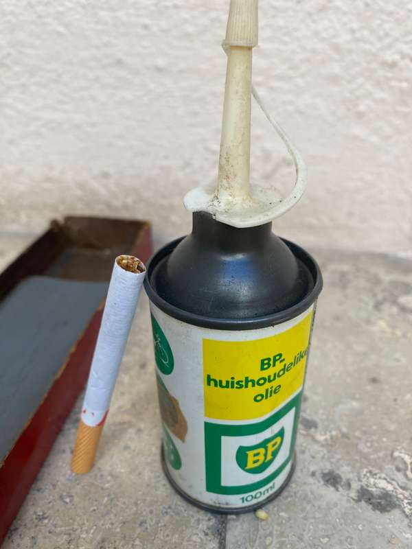 Vintage oil can BP with old sharpening stone