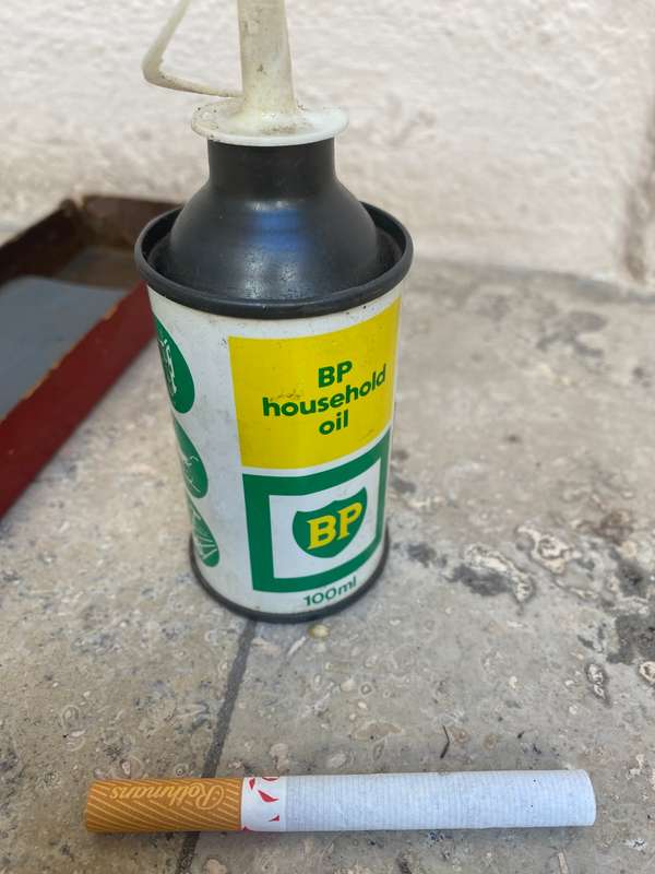 Vintage oil can BP with old sharpening stone