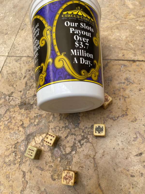 Vintage circus casino coin bucket with old poker dice