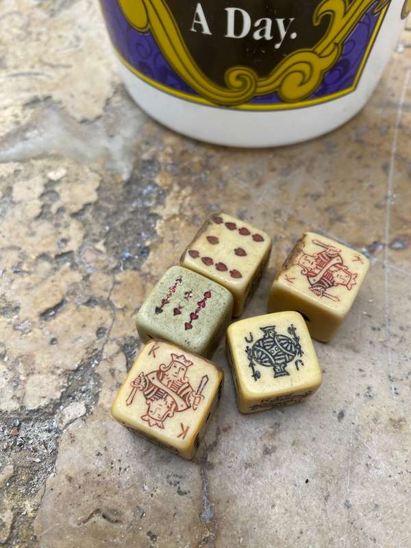Vintage circus casino coin bucket with old poker dice
