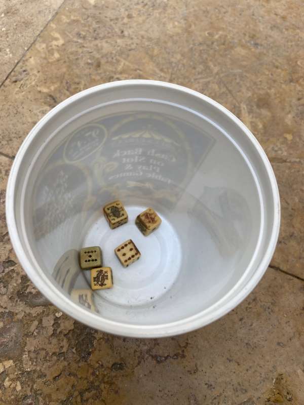 Vintage circus casino coin bucket with old poker dice