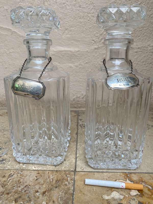 Lead crystal decanter pair with Sterling silver labels vodka and rum