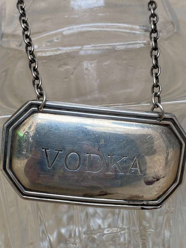 Lead crystal decanter pair with Sterling silver labels vodka and rum