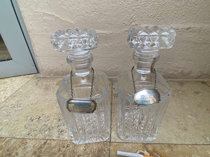 Lead crystal decanter pair with Sterling silver labels vodka and rum