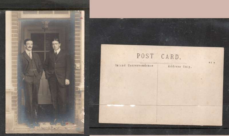 Two men of substance dressed and groomed posed in door way, photo