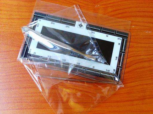 A PERFORATION GAUGE AND TWO BRAND NEW TWEEZERS!