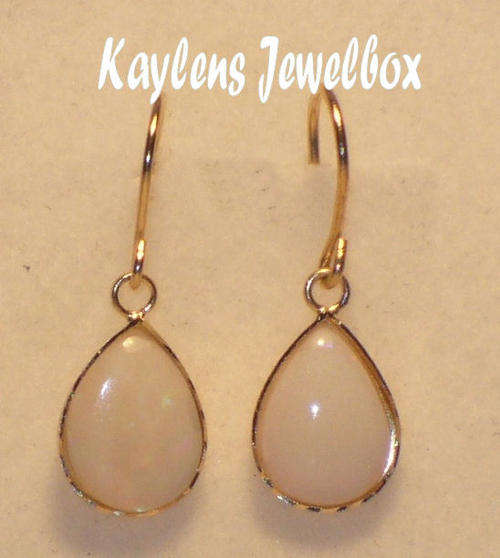 CLASSICAL, EXQUISITE: 9ct gold pear-shaped opal dropper earrings