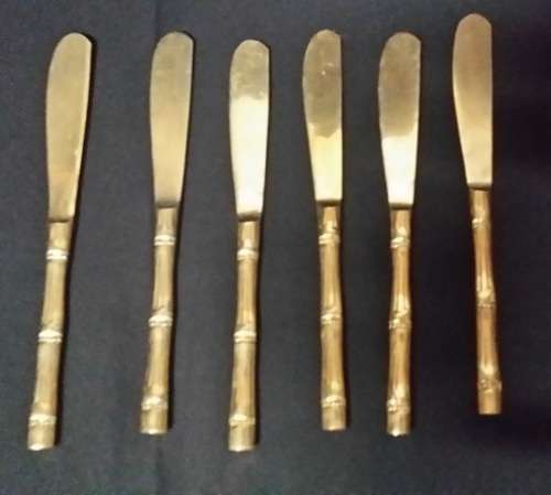 SIX BRASS BUTTER KNIVES