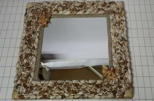A HEAVY  MIRROR  FRAMED WITH SEA SHELLS AND FAIRIES / COLLECTION ONLY )
