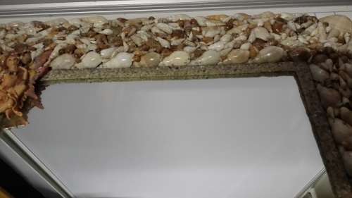 A HEAVY  MIRROR  FRAMED WITH SEA SHELLS AND FAIRIES / COLLECTION ONLY )