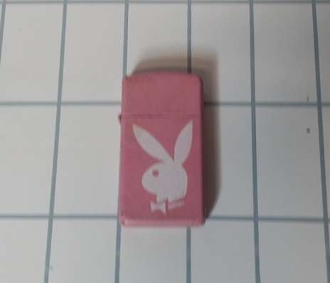 A PLAYBOY PINK ZIPPO FLUID LIGHTER PINK