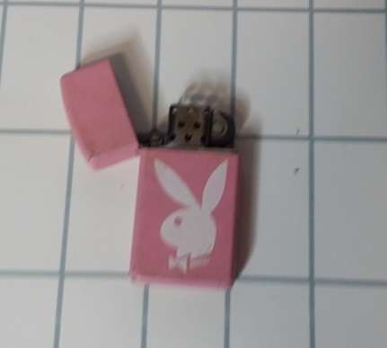 A PLAYBOY PINK ZIPPO FLUID LIGHTER PINK