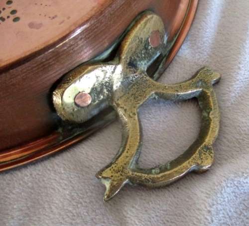 A stunning copper plated pan with brass hanging hooks.