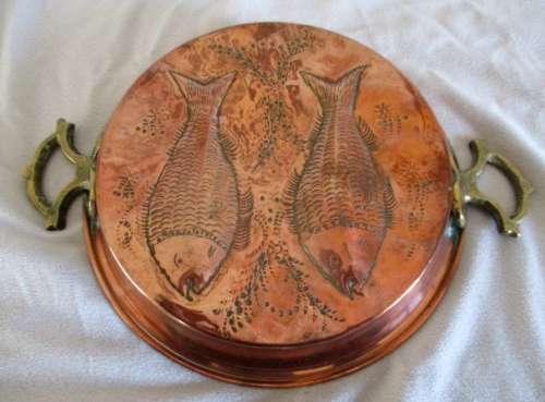 A stunning copper plated pan with brass hanging hooks.