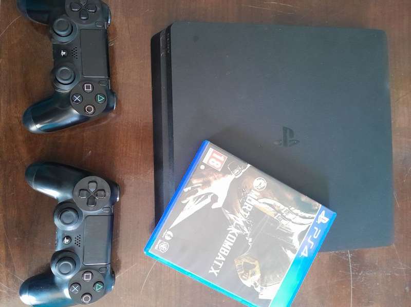 Pre owned ps4 SLIM with 2 games and cooling fan with charging port