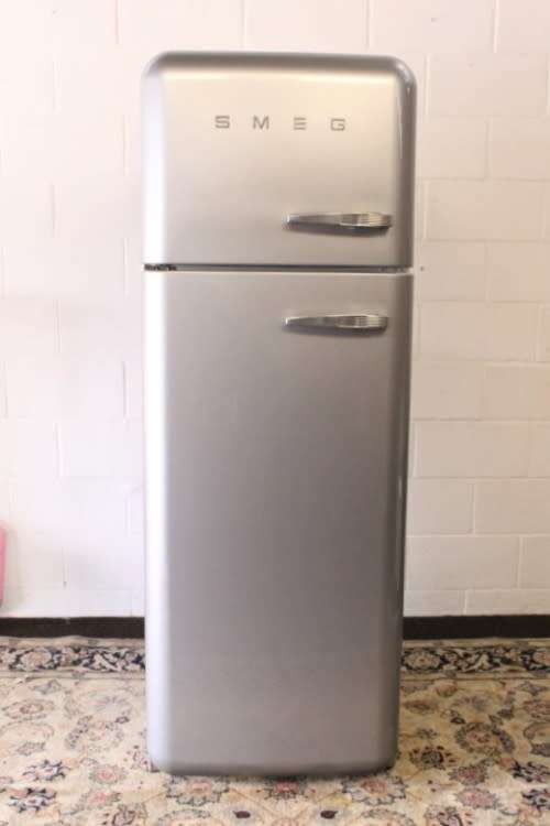 A silver original Smeg (model FAB30S7) "50's Retro Style Aesthetic" fridge-freezer combo
