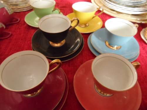 Unusual 6 cup and saucers three with matching sideplates.
