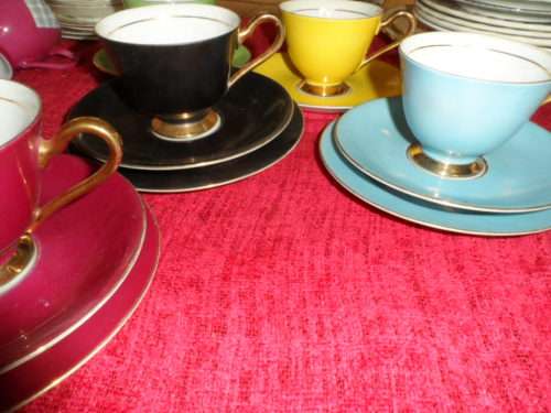 Unusual 6 cup and saucers three with matching sideplates.