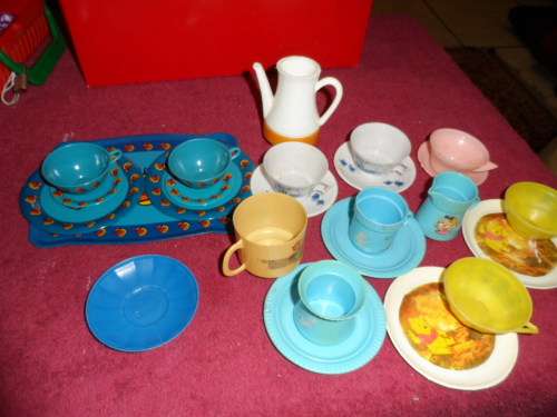 Tinplate and plastic cups and saucers and plates.
