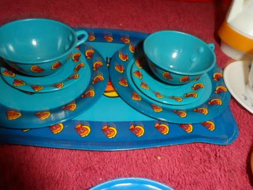 Tinplate and plastic cups and saucers and plates.