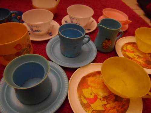 Tinplate and plastic cups and saucers and plates.